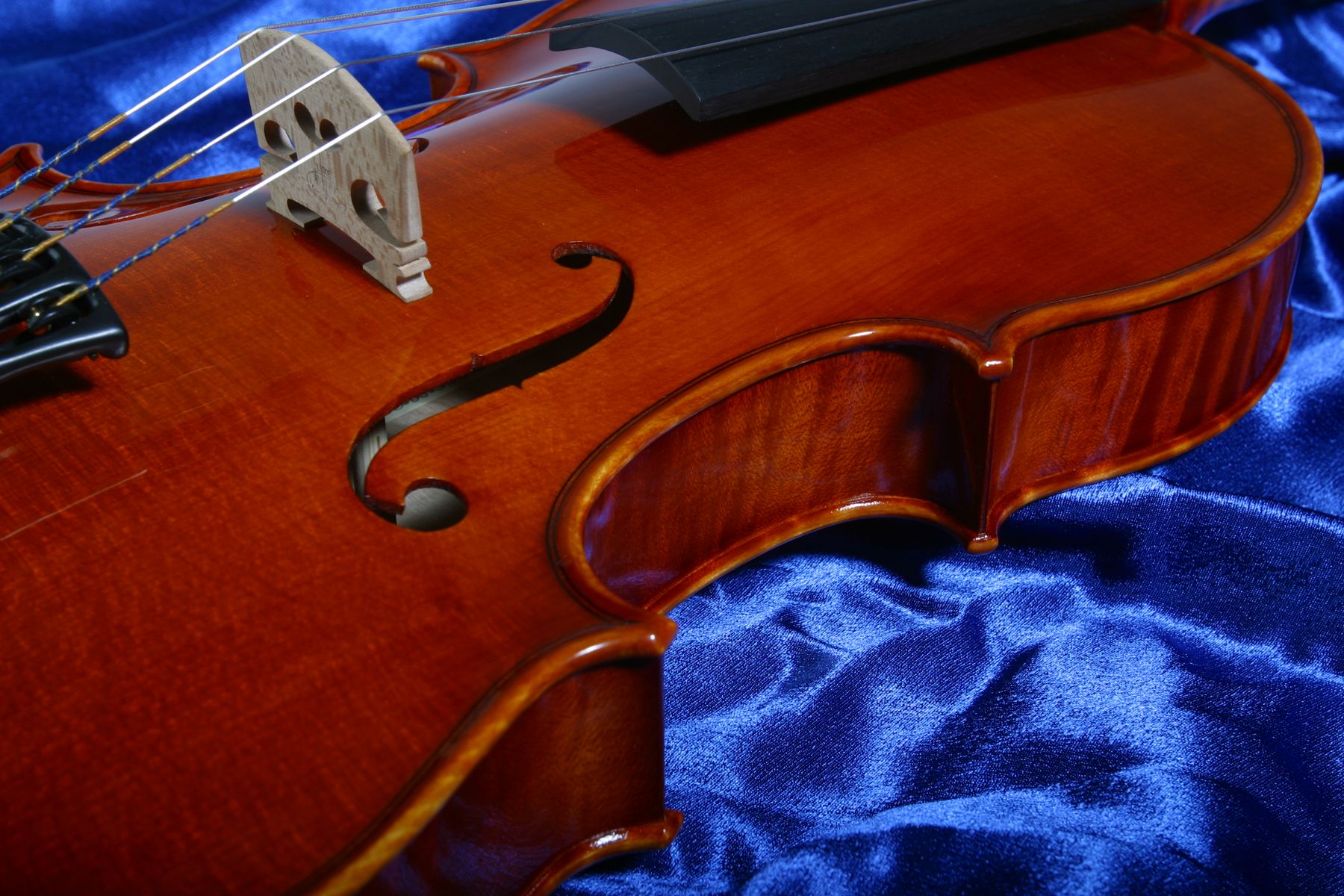 Handmade violin on blue silk